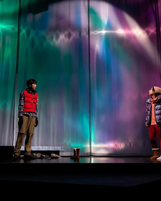 Aurora-inspired cyclorama wash in a theatrical production